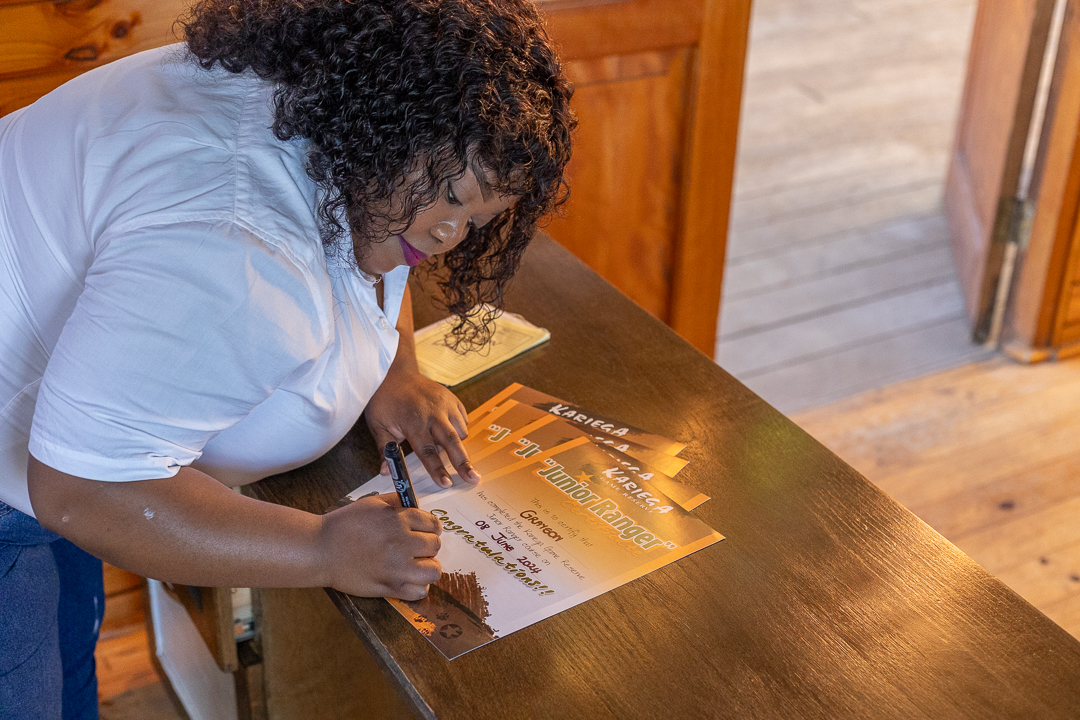 Ntosh signing off a junior ranger certificate - photo credit to Brendon Jennings