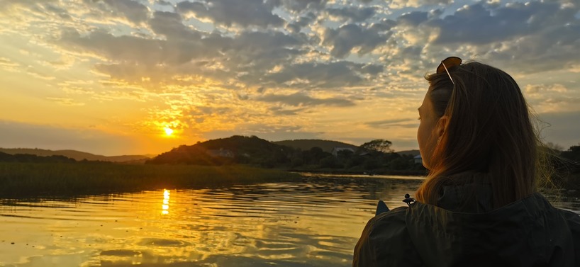 Volunteer watching the sunset on the river